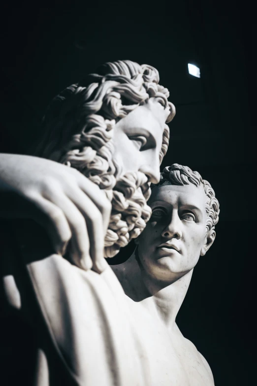 a marble statue of a man with curly hair and beard