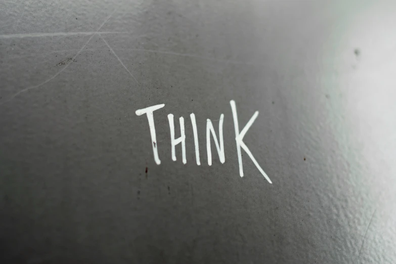 a wall with the word think written on it