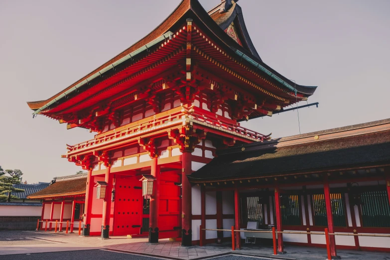 an old asian building that has red pillars