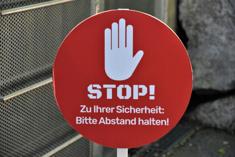 a stop sign in german that has been painted with white letters