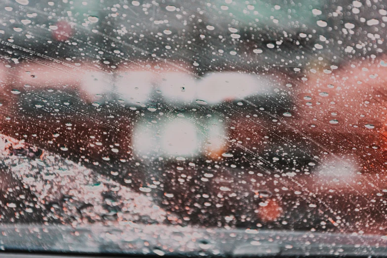 the view out the side window of cars on a rainy day