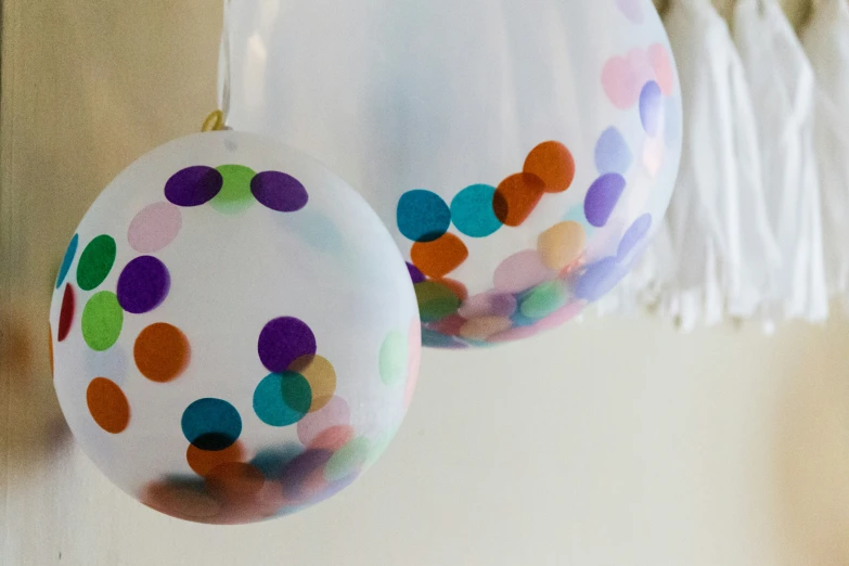 a pair of party balloons on the side of a house