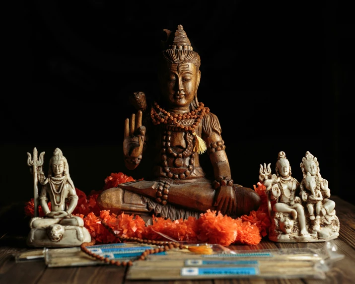 a buddha statue sitting on top of a wooden table