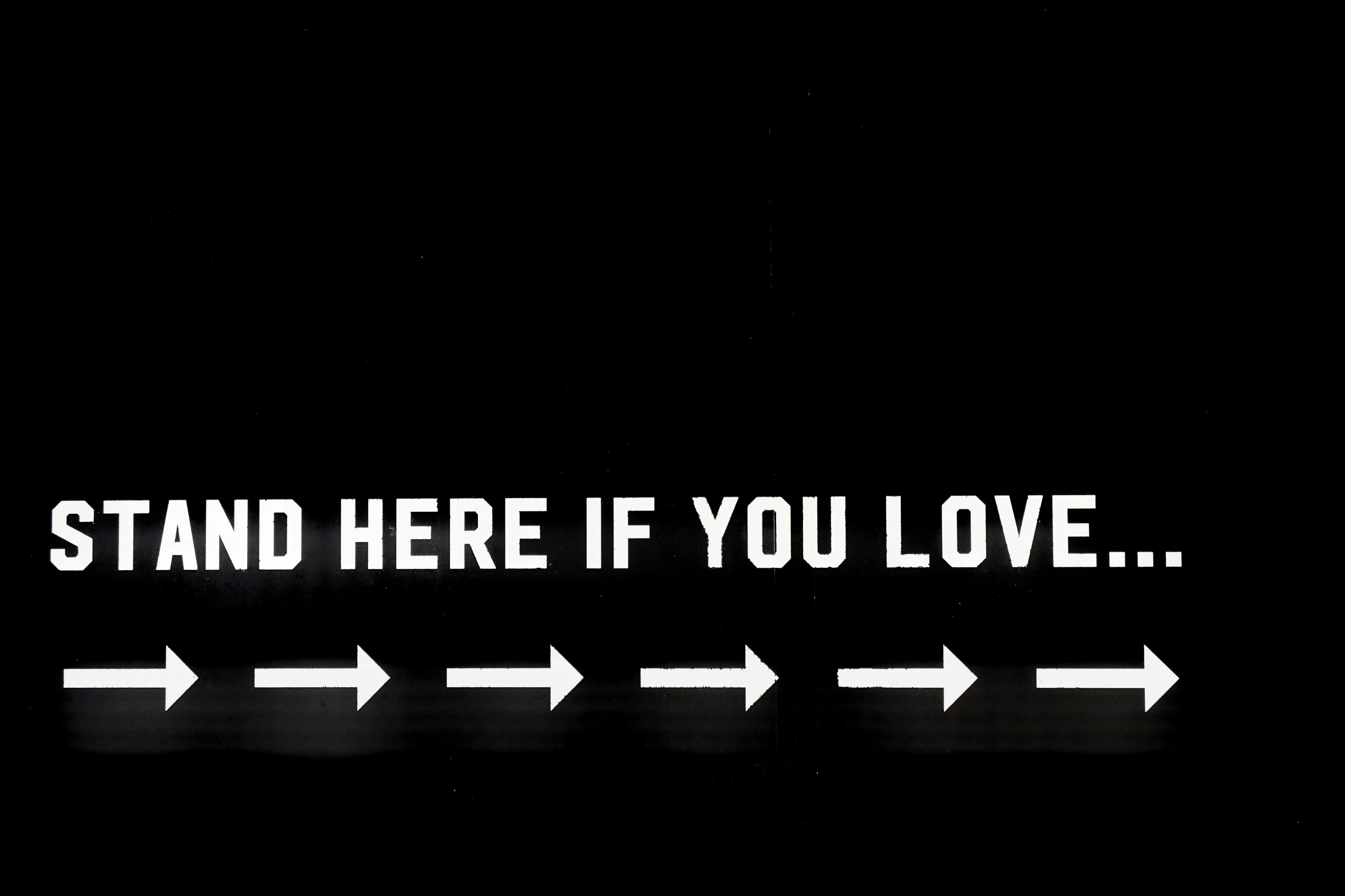 a line with arrows that say stand here if you love