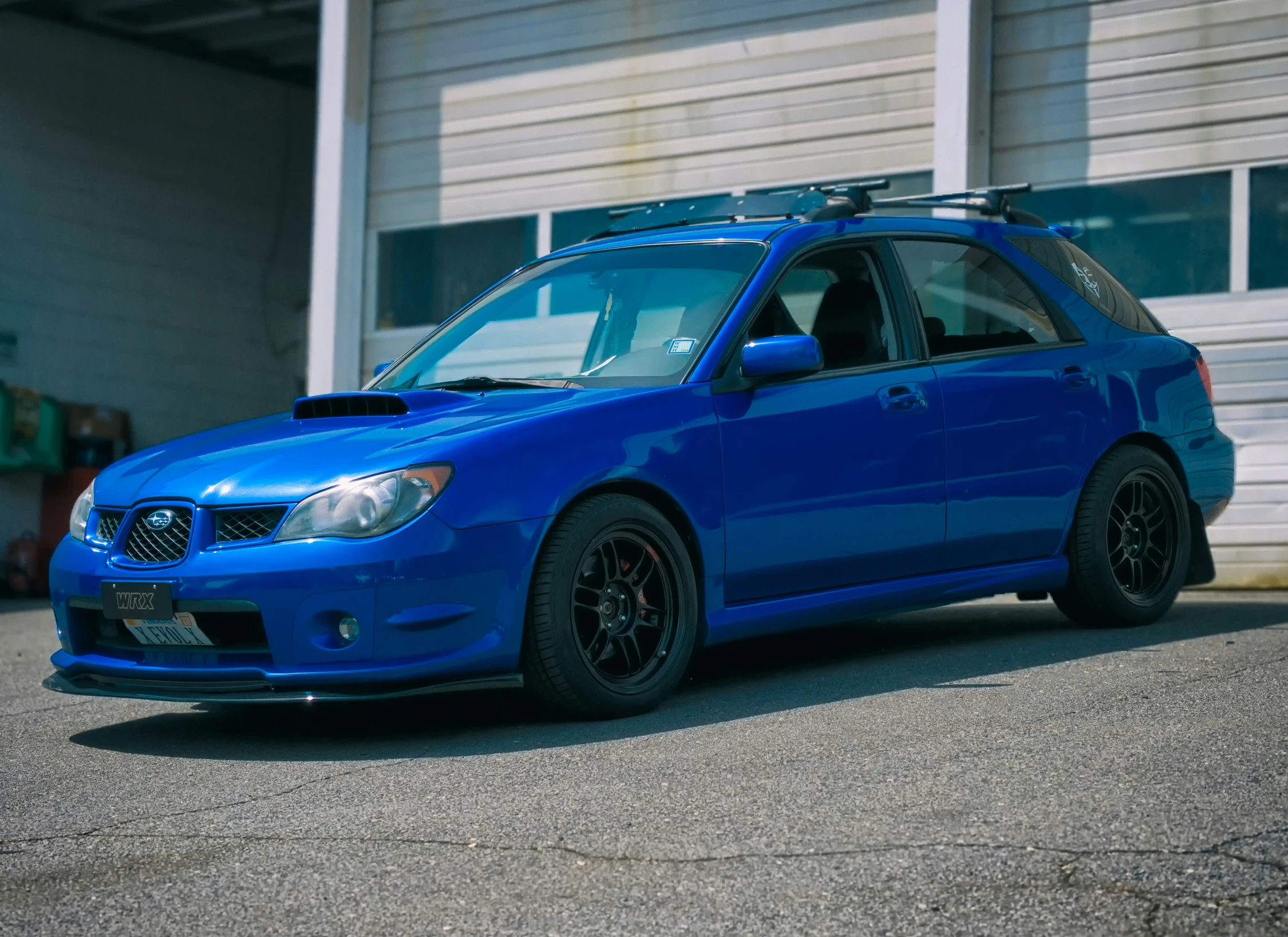 a blue car with a flat tire and an antenna on the roof