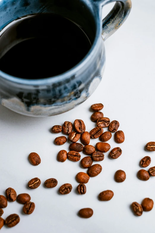 coffee beans spilled out of a mug