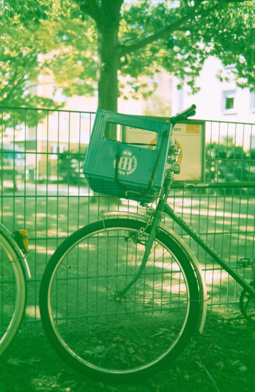 two bikes locked up in front of a fence