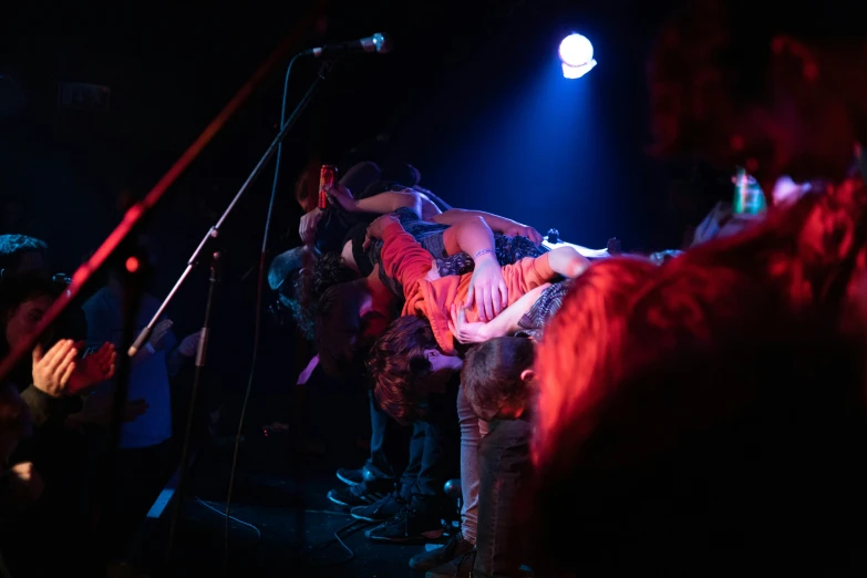 the image of a woman singing on stage during a party