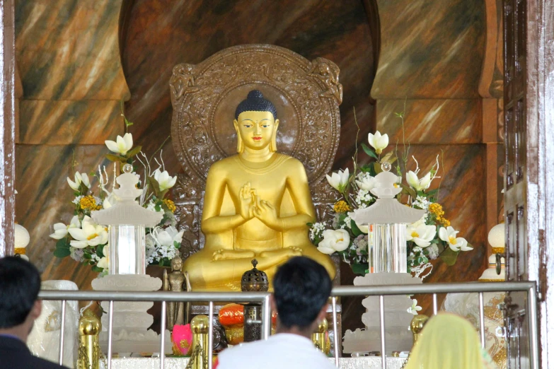 a golden buddha statue in the center of a room