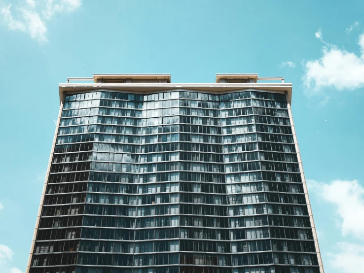 a building with glass windows against a blue sky