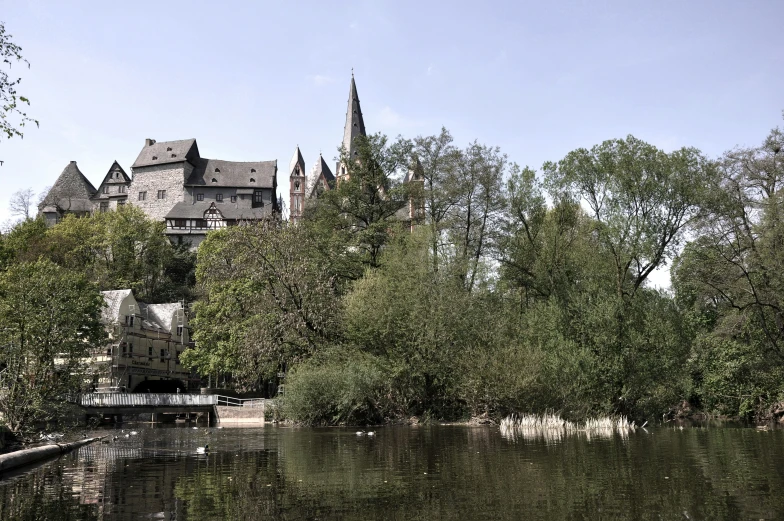 a lake with houses on the side and trees all around