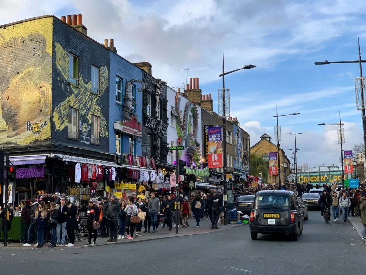 a crowded street with various stores and people