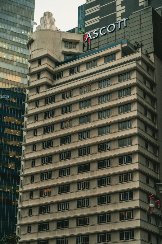 the top part of an office building next to tall buildings