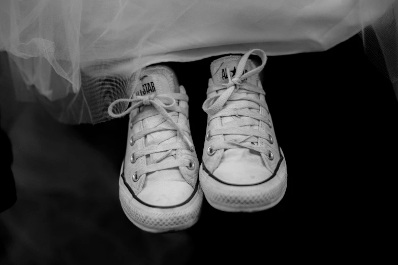 there are white shoes sitting on top of a bed