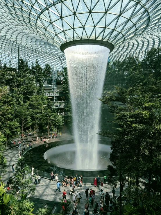 tourists at the beautiful waterfall exhibit at singapore's flower dome