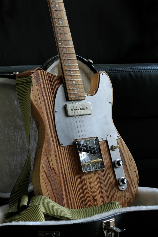 a white electric guitar with a brown and silver neck