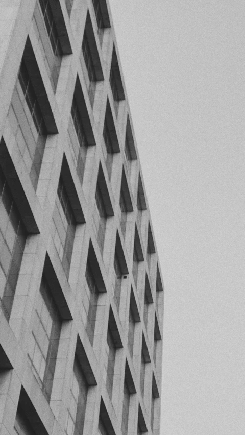 a greyscape picture of a concrete skyscr