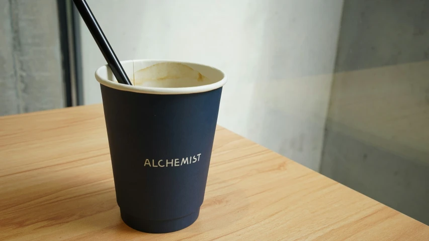 a cup sitting on top of a wooden table