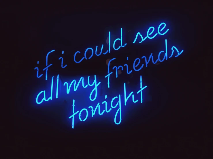 a neon sign in a dark background has words
