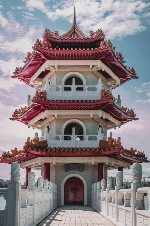 a chinese tower stands near a paved street