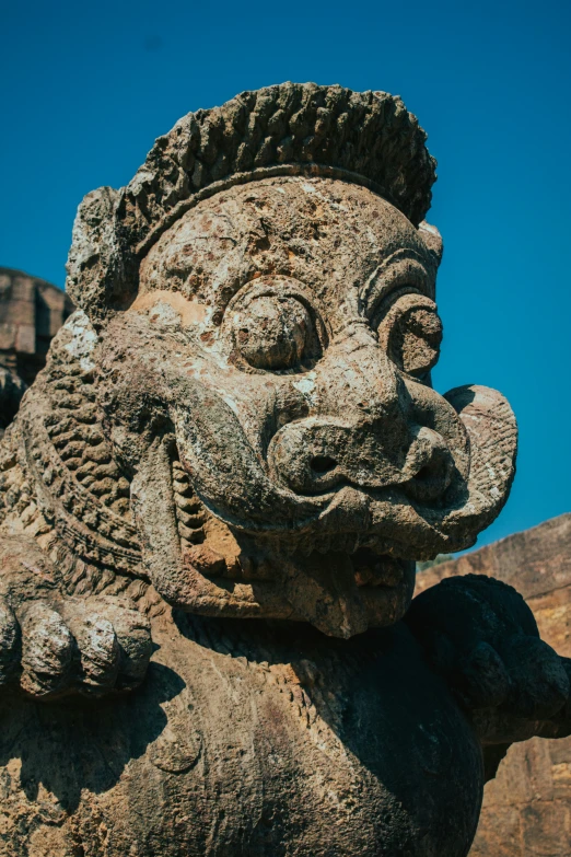 statue of a face on the outside of a temple