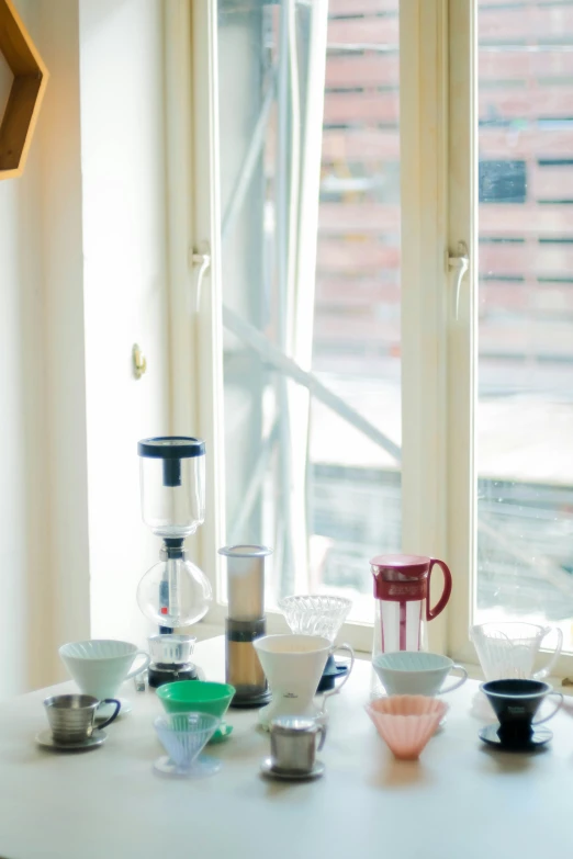 cups, blenders and bowls sit on the table