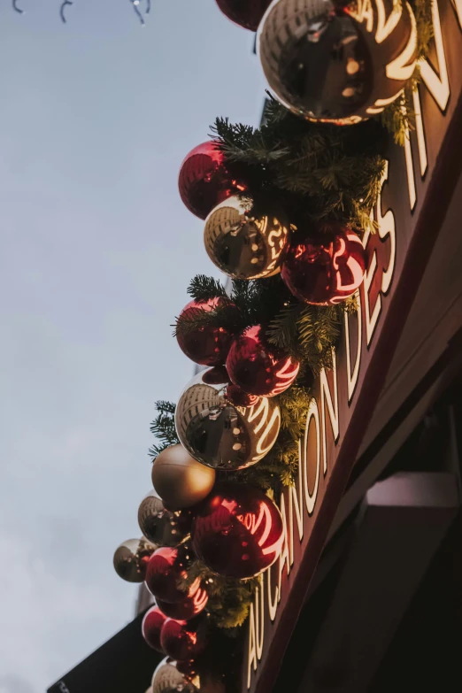 a tall christmas tree with red ornaments and lights