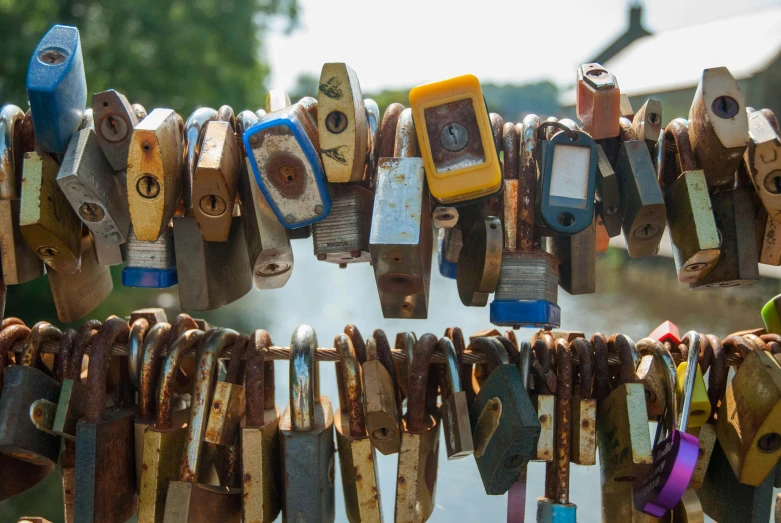 the old and used padlocks are hanging from strings