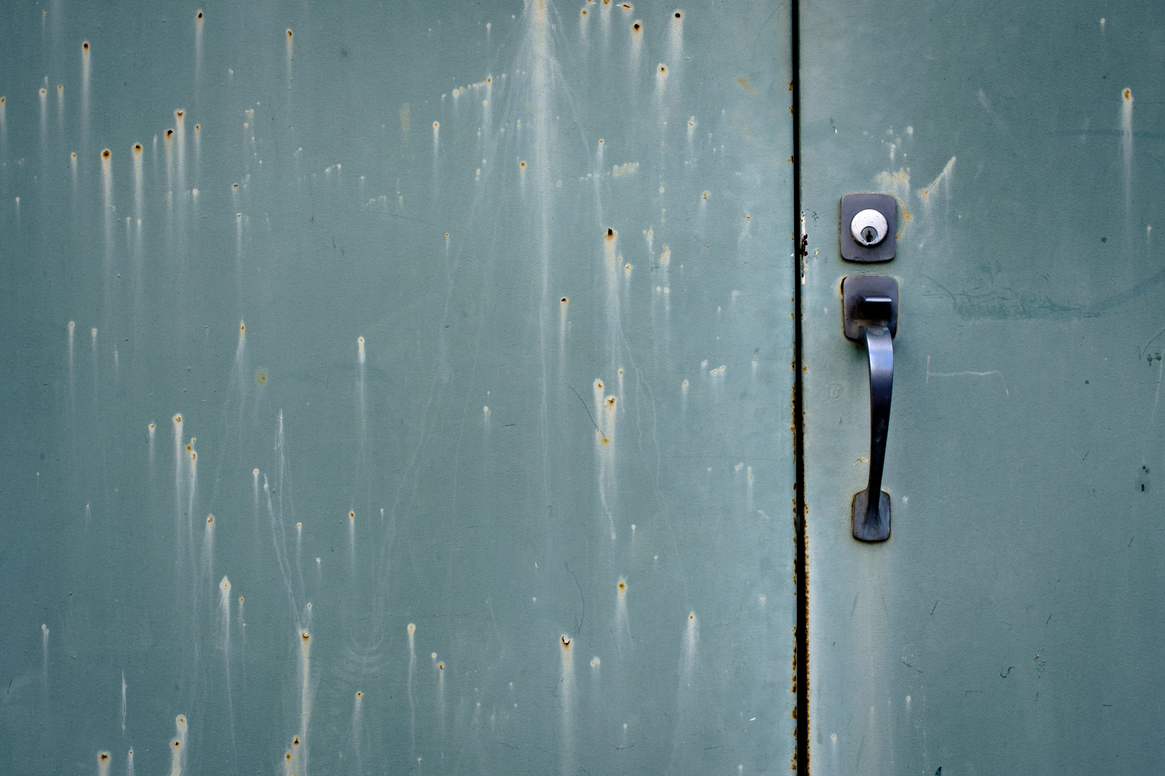 a close - up image of an old metal surface with holes