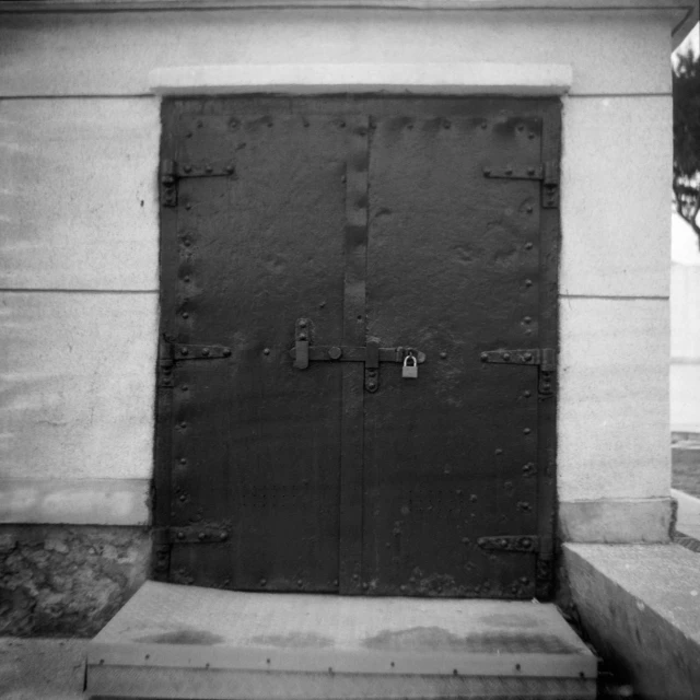 a wooden door sitting on top of a stone wall