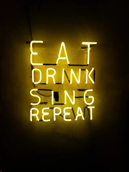 eat drink sing repeat neon sign in the dark