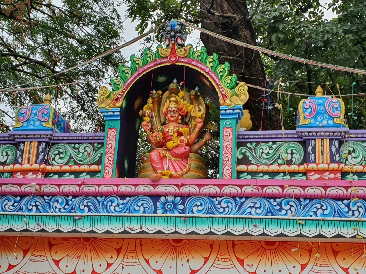 a colorful sculpture and trees in the background