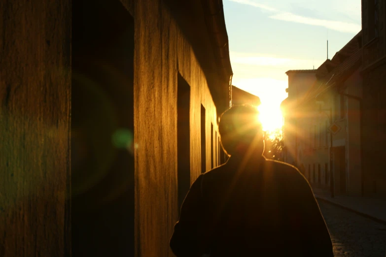 the man is walking through an alley way