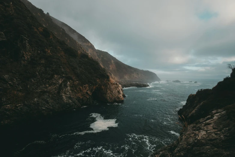 a beautiful view of water with a cliff out side