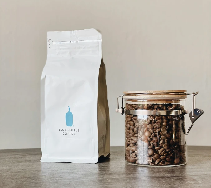 a bag and a pot filled with coffee beans