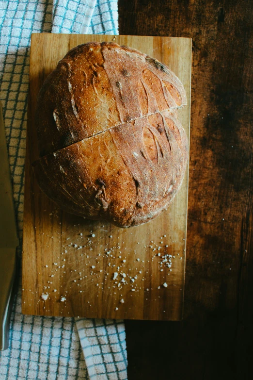 a loaf of fresh bread is sitting on a  board