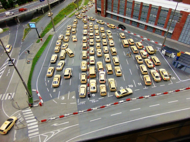 a parking lot filled with taxis on a busy street