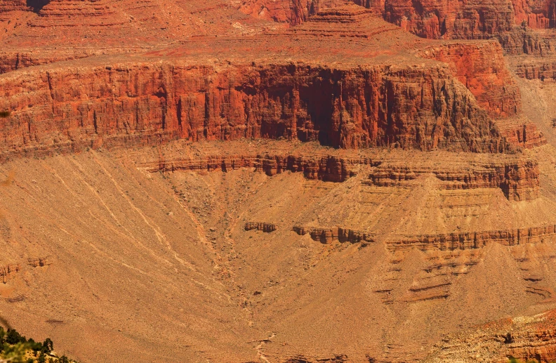 the view of a very wide canyon with mountains in the background