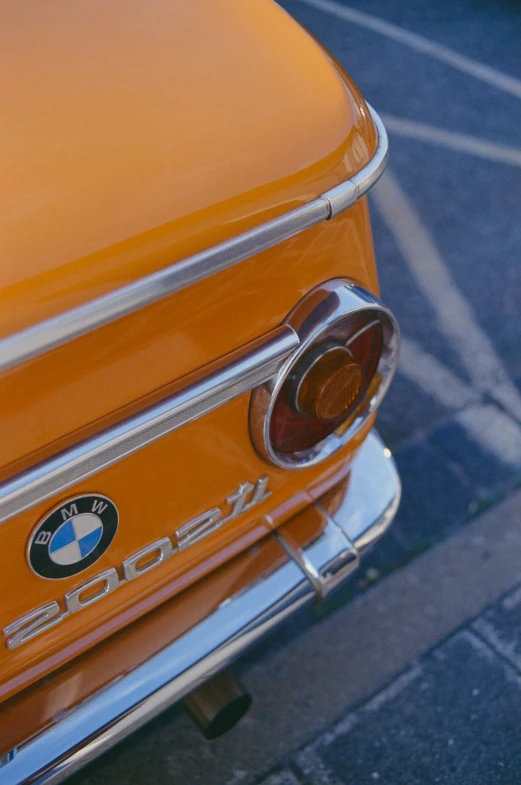 a close up of a bmw logo on the front of an old car