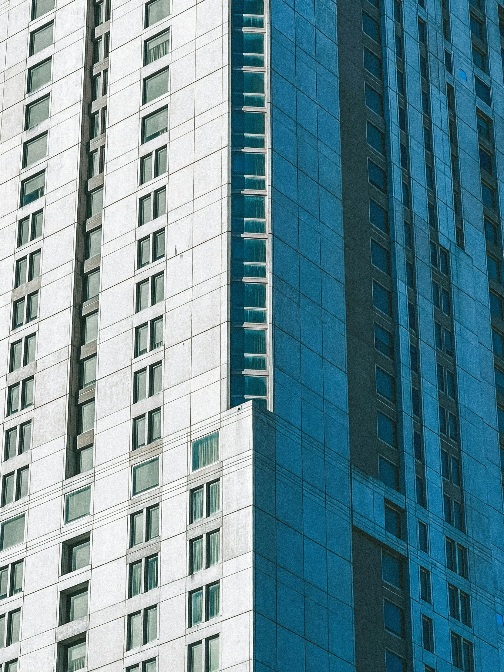 two tall buildings side by side, with a bus on top