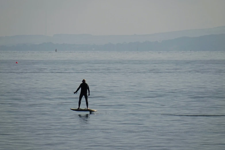 a man standing on his surfboard in the water