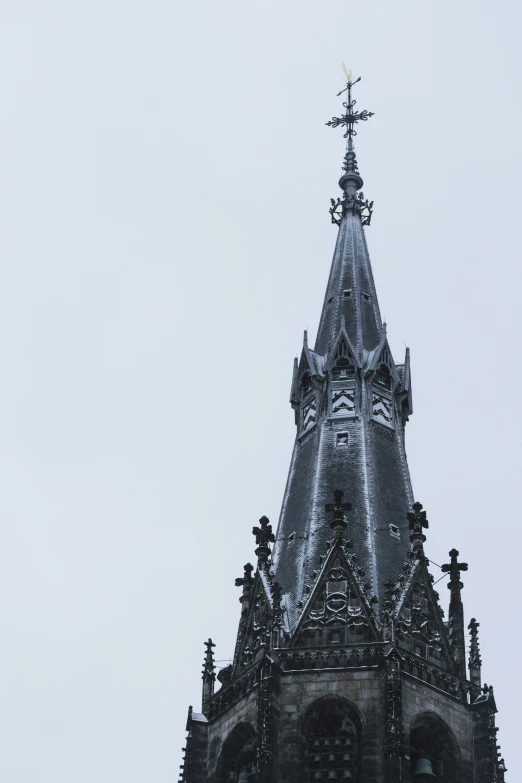 the tower of a building with a weather vein is shown