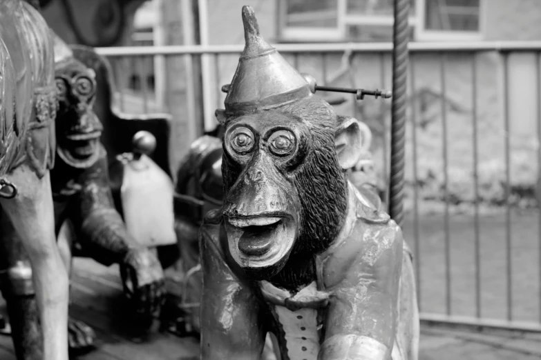 a wooden statue of a monkey wearing a hat and wearing an odd face