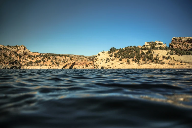 the view looking over the calm ocean at a rocky area