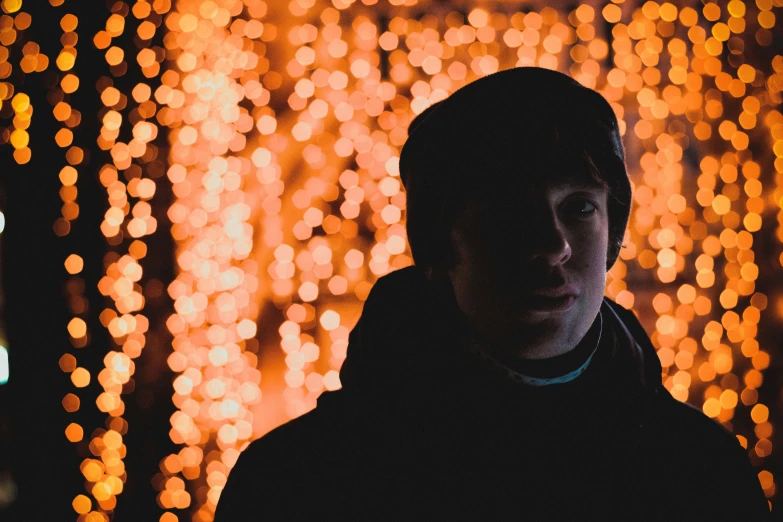 a man standing in front of a large background filled with light