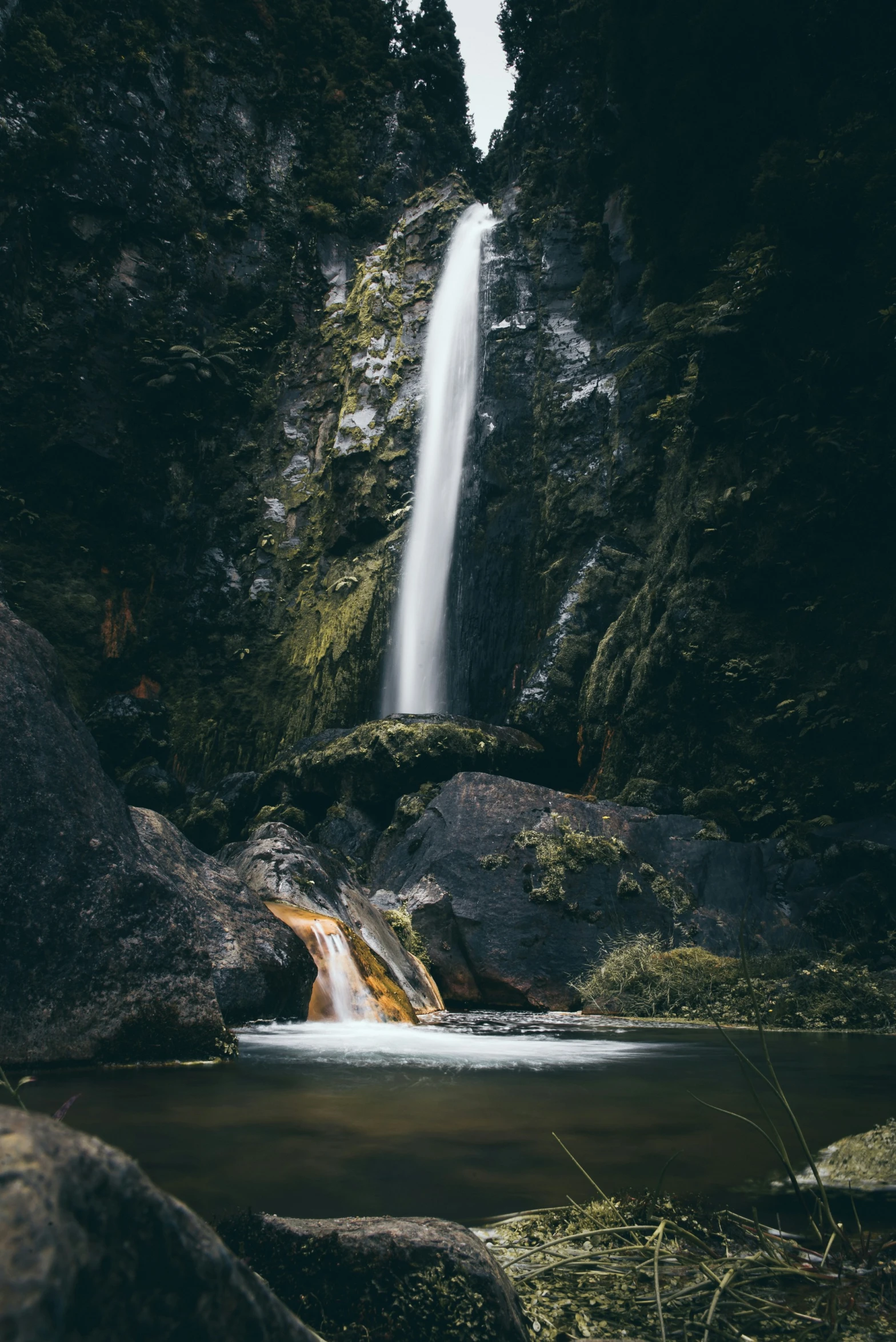 this is a waterfall that is going into the woods