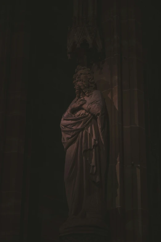 a statue of jesus is shown in front of a column