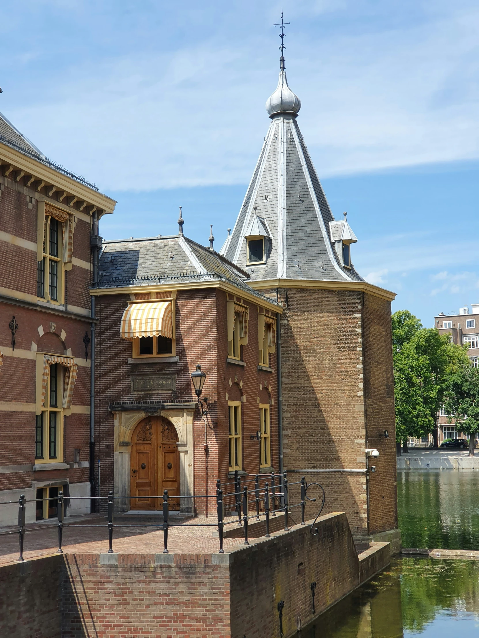 a po of a large brick building with a tower near the water