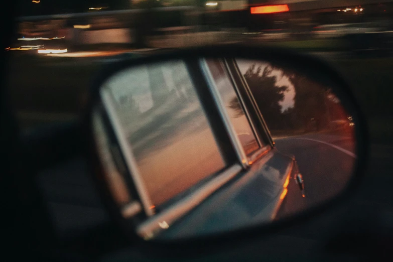 a picture of the reflection of a truck in a rear view mirror