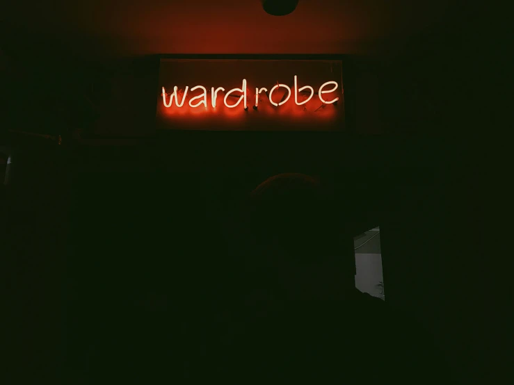 a neon sign is lit in the dark